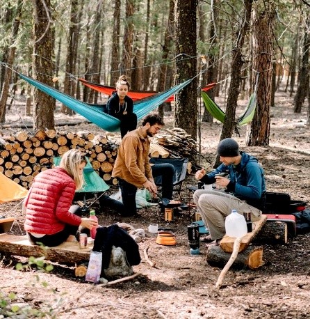 Group of friends camping with hammocks