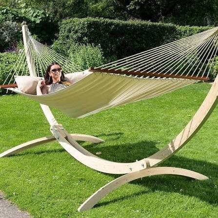 Woman relaxing in hammock on wooden stand
